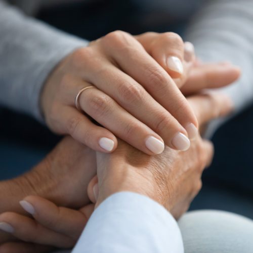 Close,Up,Adult,Daughter,Holding,Mothers,Hand,,Gesture,Symbol,Of